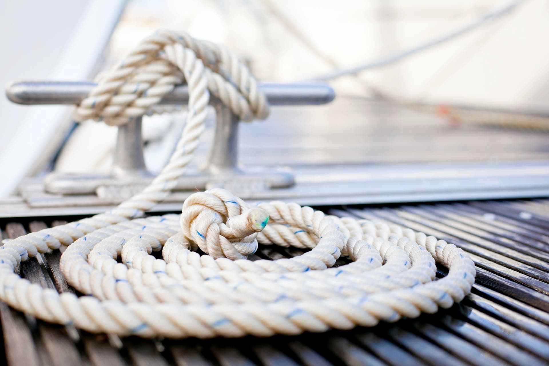 Boat detail of a rope tied to a metal bar